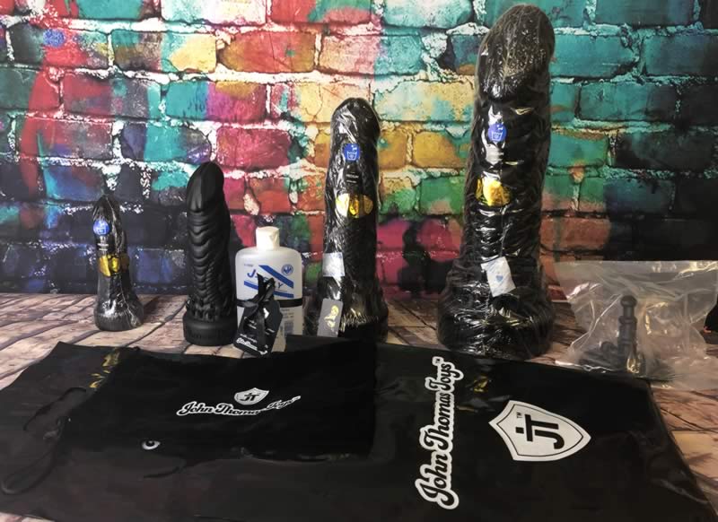 Image showing all four Barbarian dildos and their storage bags and free suction cup adaptor