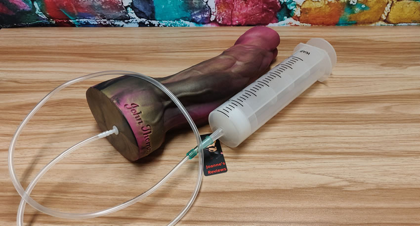 Image showing the huge syringe next to the Sampson dildo