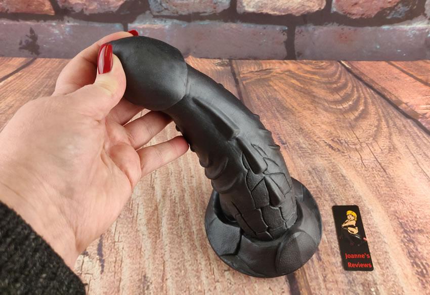 Image showing my hand bending the Sinnovator Typhon dildo