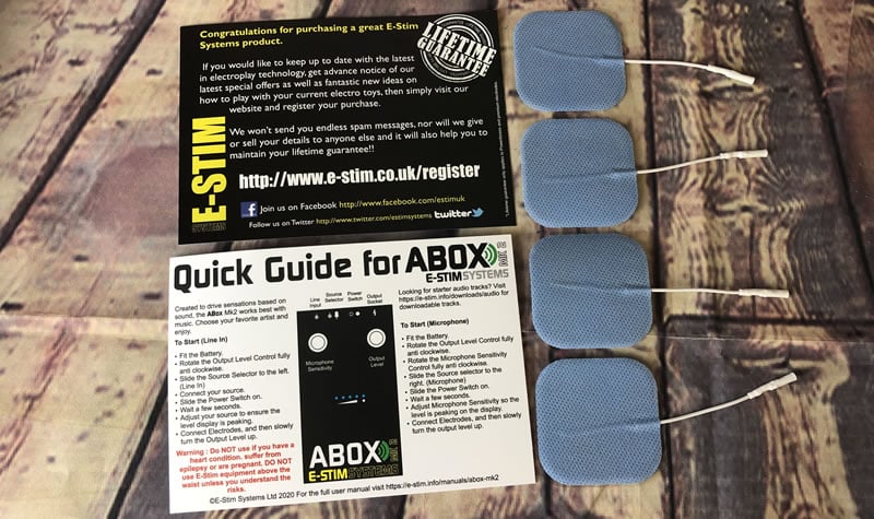 Image showing the quick start guide, warranty card and the included electrodes